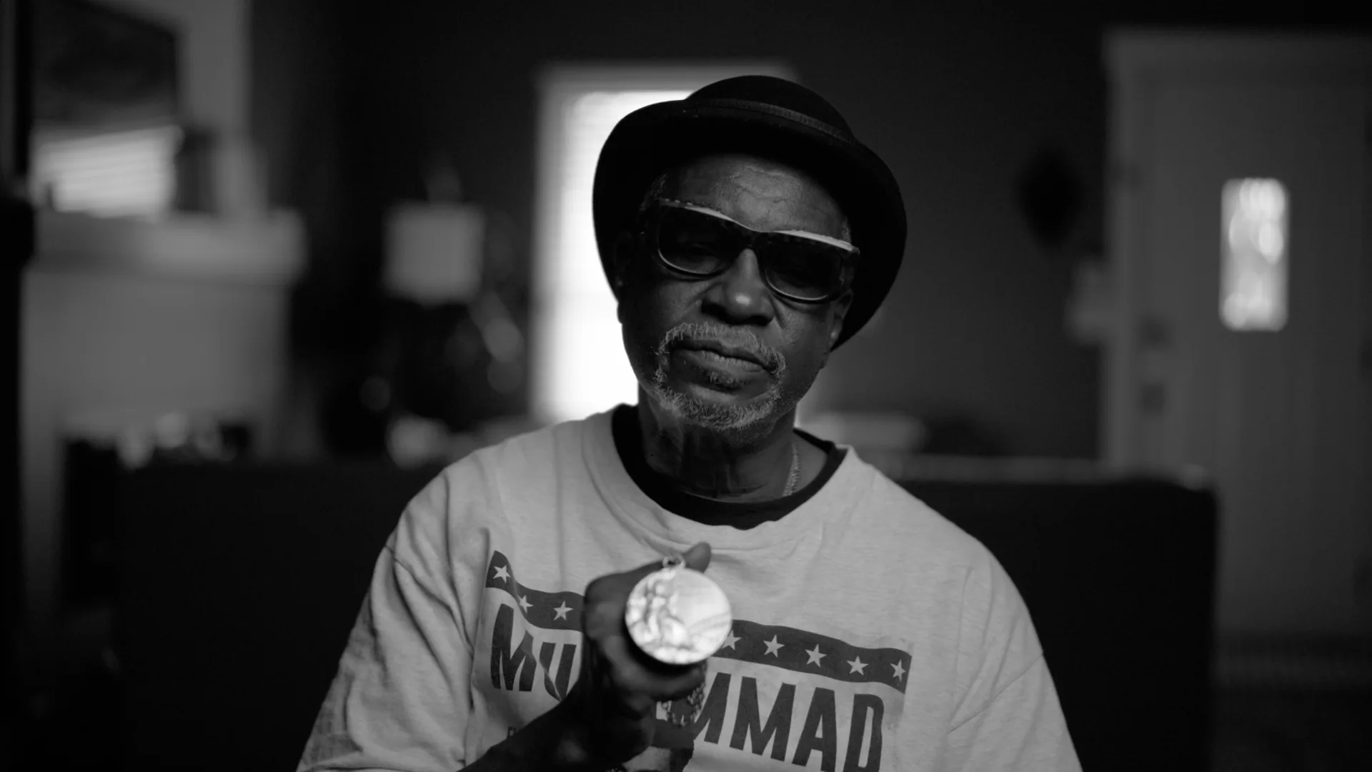 The Sugarman subject holding a medal