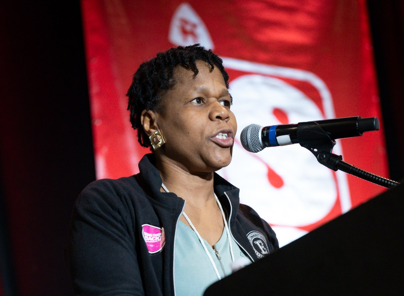 An educator speaking into a microphone